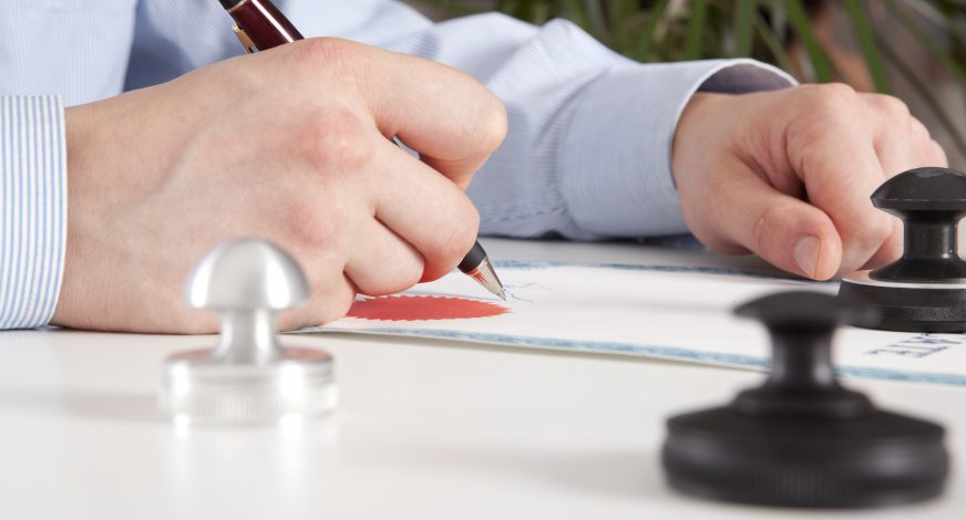 Lawyer, notary signs the documents from our office